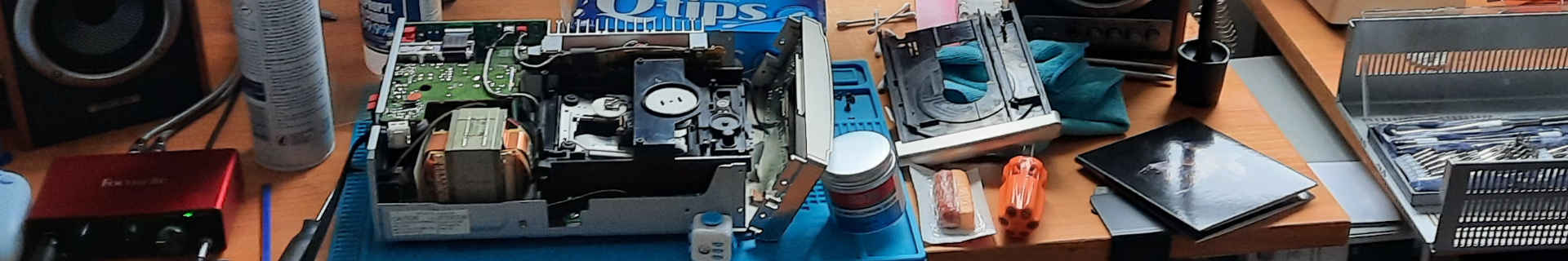 A picture of my desk with a CD player dissected on it